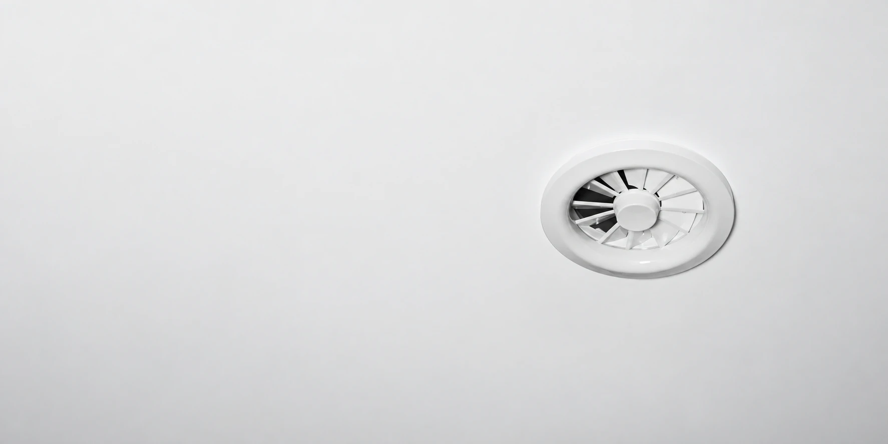 White Nova+ ceiling diffuser integrated into a clean, pale ceiling.
