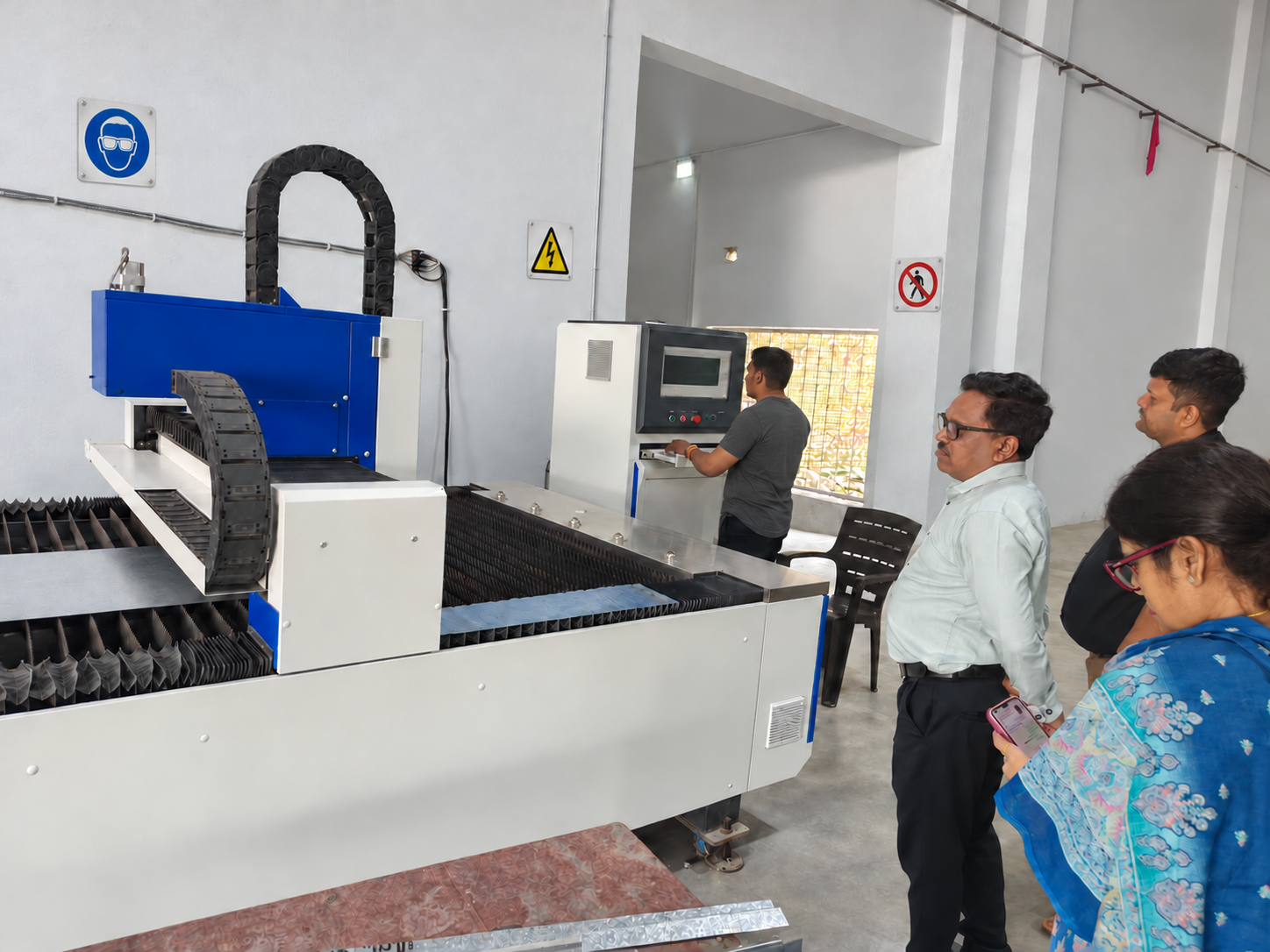 Visitors beside manufacturing equipment at Gerhman’s India factory